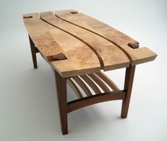 a wooden bench made out of plywood and some sort of slatted design