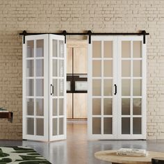 an open room with white doors and brick walls