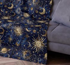 a couch with a blue and gold blanket on it