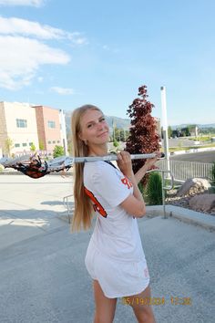 a young woman holding a baseball bat in her right hand