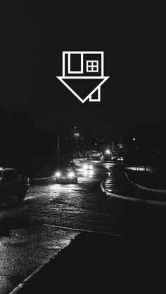 a black and white photo of cars driving down a street at night with the letter e above it