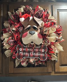 a christmas wreath with a dog's face and words on it that says, we woof you a merry christmas