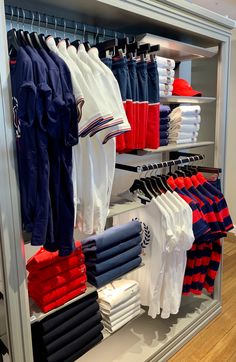 an assortment of men's clothing on display in a store