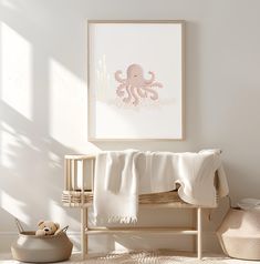 a baby's room with an octopus print on the wall and a white blanket