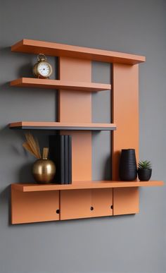 an orange shelf with two vases and a clock on the top, against a gray wall