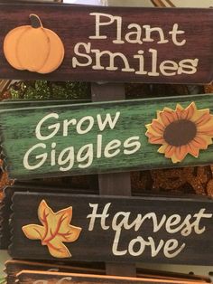 three wooden signs that say plant smiles, grow giggles, harvest love and harvest pumpkins