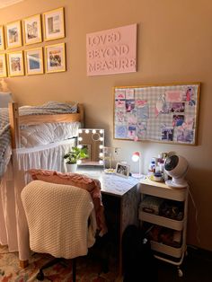 a bedroom with a bed, desk and chair in it's corner next to pictures on the wall