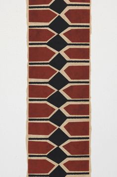 a red and black area rug on a white wall