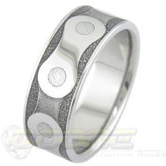 a wedding ring with two circles and black glitter inlays on the inside of it