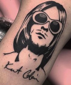 a tattoo with a man's face wearing goggles and the words eat out on it