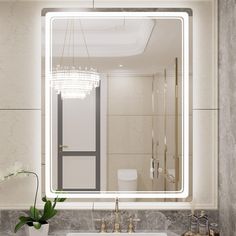 a bathroom with a sink, mirror and lights on the wall above it's counter