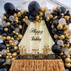 a black and gold birthday party with balloons