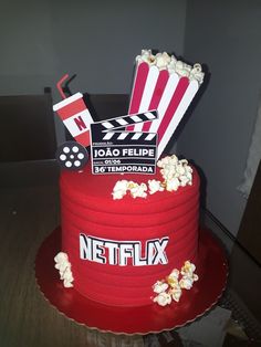 a red cake with popcorn and movie claps on top