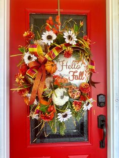 a red door with a fall wreath on it