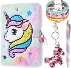 the unicorn key chain is next to a phone case with a pen and charm on it