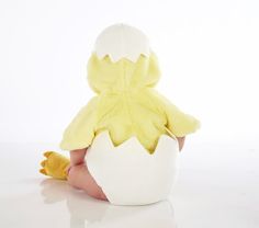 a baby is sitting in an egg shell