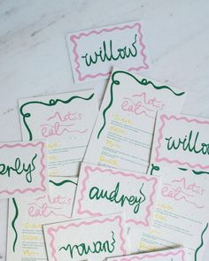 six handmade wedding stationery cards in pink, green and yellow with calligraphy