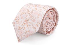 a pink tie with leaves on it is laying on a white surface and there is no image to describe