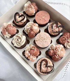 a box filled with lots of cupcakes on top of a table