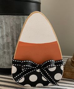 an ironing board with a polka dot bow on it next to a canister