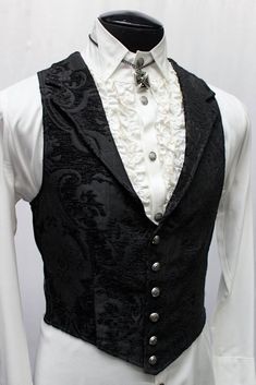 Note: These vests are very fitted. Check the size measurements below very carefully to find the size that will fit you best. A Victorian gentleman's vest with class. Great for formal occasions, can be worn under a suit jacket or by itself. Made in rich black on black tapestry fabric with black satin lining and back. This vest has a very flattering tapered fit and ties in back with satin belting so it can be made tighter in the waist. Fastens in front with six metal buttons. A notched collar adds Aristocrat Vest, Classy Gentleman, Black Tapestry, Country Gentleman, Style Gentleman, Victorian Gentleman, English Gentleman, Tapestry Fabric, Fashion Art Illustration