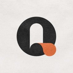 the letter q is made up of black and orange circles on a white fabric background