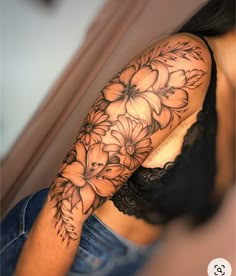 a woman's arm with flowers on it