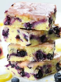 blueberry lemon blond blondies are stacked on top of each other with fresh blueberries