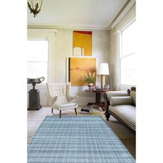 a living room filled with furniture and a blue rug