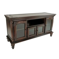 a large wooden entertainment center with glass doors and carvings on the front, in an antique style