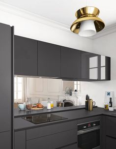 an image of a kitchen with grey cabinets and black counter tops on the phone screen