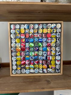 a wooden frame filled with lots of different types of buttons