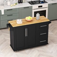 a black kitchen island with wooden top in the middle of a floored kitchen area