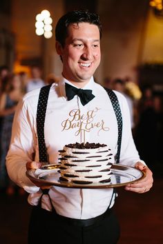 a man holding a plate with a cake on it