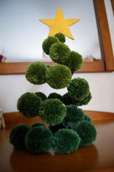 a christmas tree made out of broccoli on a table with a star above it