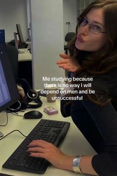 a woman sitting in front of a computer with a message written on the screen above her