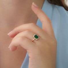 "14k Gold Emerald and Diamond Ring / Solid Gold Diamond Ring / Emerald Engagement Ring / Halo Rectangular Setting / Dainty Emerald Ring ✔ Handmade ✔ Setting Size: 9.5 x 7.5 mm ✔ Diamond Ct Weight: 0.09ctw ✔ Emerald Ct Weight: 1.15 All our emeralds are treated natural emeralds (Emeralds are typically treated with oil or other \"fillers\" to draw the filling substance into any surface-reaching fissures to improve the clarity of the emerald) ✔ Band Thickness: 1.2mm ✔ Solid Gold ✔ Natural Diamonds a Ring Designs With Green Stone, Emareld Ring Design, Emerald Finger Ring Gold, Emerald Rings Design, Gold Rings With Green Stone, Green Emerald Ring Gold, Gold Ring Emerald Stone, Green Diamond Ring Engagement, Emerald Gold Rings