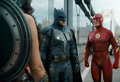 the flash and batman are standing next to each other