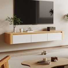 a flat screen tv mounted to the side of a wall above a coffee table in a living room