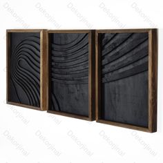 three black and brown paintings hanging on the wall