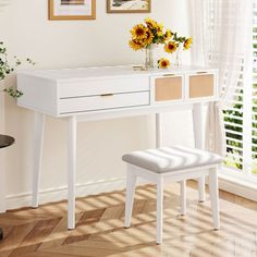 a white desk and chair in a room with sunflowers on the window sill