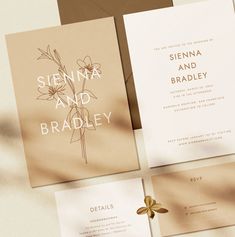 the wedding stationery is laid out on top of each other