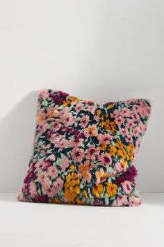 a colorful pillow sitting on top of a white table