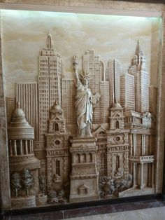 the statue of liberty is on display in front of a cityscape wall mural