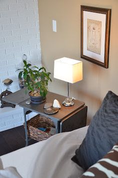 a living room with a couch, coffee table and potted plant on the corner