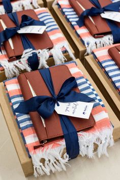 several wrapped gift boxes sitting on top of each other with blue and red ribbons tied around them