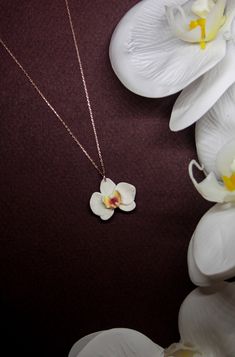 Material: White orchid flower made with polymer clay. They made by hand from start to end. No two pieces will be exactly alike. Like a real flowers! Also, they are very lightweight. The metal parts of necklace is 24K rose gold plated sterling silver, so you can use your jewels for many years. Necklace metals (sterling silver) are antiallergenic.  (Also, if you want to change the chain's color (like silver or yellow gold plated) you can send us a message.!) All of items are designed and carefully Luxury Flower Shaped Nature-inspired Necklace, Orchid Flower Necklace For Gift, Flower-shaped Polymer Clay Necklace For Gift, Flower Shape Polymer Clay Necklaces For Gifts, Flower Shaped Polymer Clay Necklaces As Gift, White Necklaces With Handmade Flowers As Gift, Flower Shaped Polymer Clay Necklace For Gift, Polymer Clay Flower Necklace For Gift, White Necklaces With Handmade Flowers For Gift