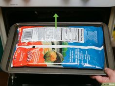 a bag of frozen food sitting on top of a metal tray with an arrow pointing to it