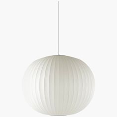 a large white ball light hanging from a ceiling