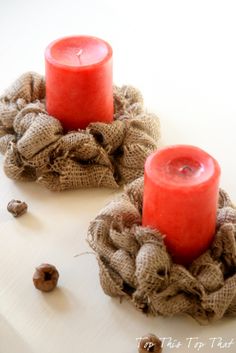 two red candles sitting on top of burlocks